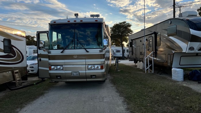 Motorhome parked on a gravel site at sunset