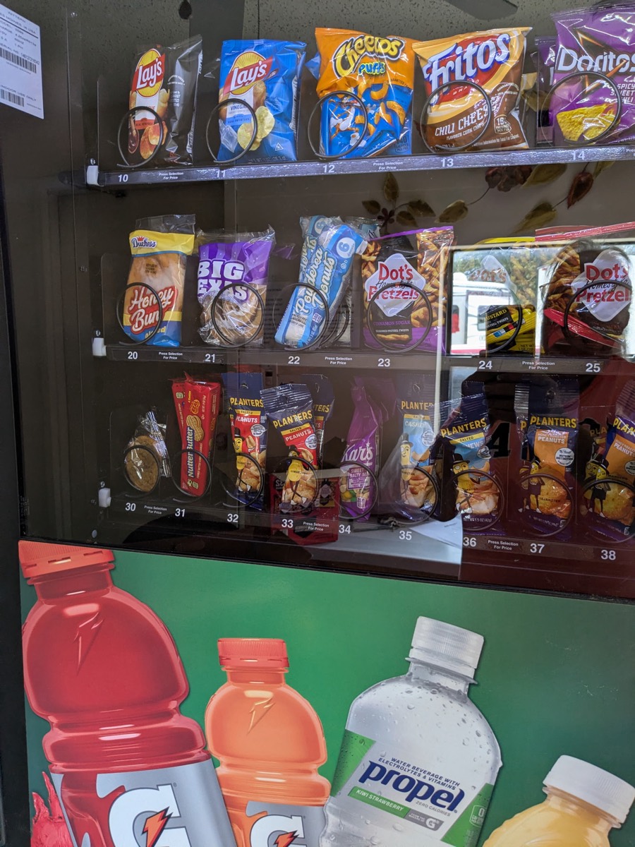 Snack vending machine stocked with chips, pastries and nuts